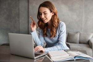 Smiling woman using a laptop
