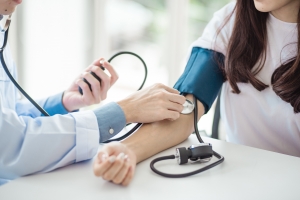 Medical professional taking vital signs